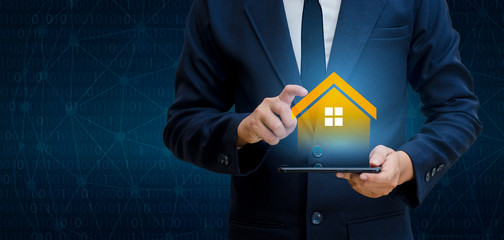 The house is in the hands of the business man  home icon or symbol