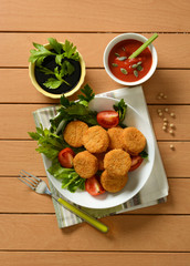 small soy burger with soy sauce and tomato sauce and sunflower seeds