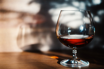 Front view of cognac in the glass on the table