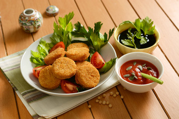 small soy burger with soy sauce and tomato sauce and sunflower seeds