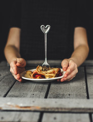 Pancakes (crepes) on a wooden surface