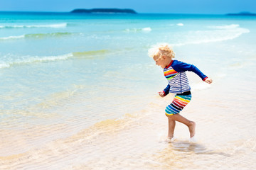 Fototapeta premium Child on tropical beach. Sea vacation with kids.
