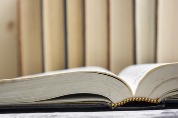 Open book, hardback books on wooden table. Back to school. Copy space