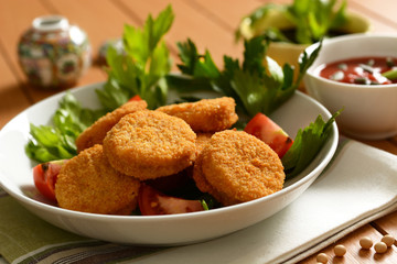 small soy burger with soy sauce and tomato sauce and sunflower seeds