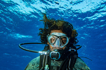 Scuba diver smiling underwater selfie portrait in the ocean