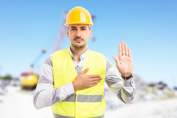 Confident builder or contractor making oath vow gesture.