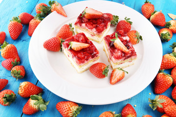 strawberry cake with fresh strawberries and whipped cream.