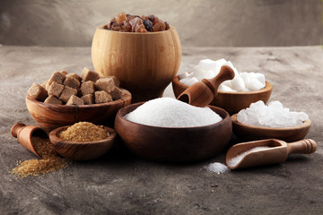Various types of sugar, brown sugar and white on table
