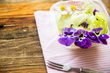 Spring salad with radishes, edible flower and sauce, selective focus