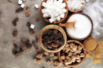 Various types of sugar, brown sugar and white on table