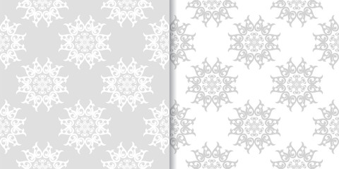 Light gray floral backgrounds. Set of seamless patterns