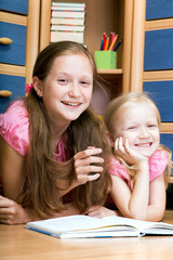 two girls reads book