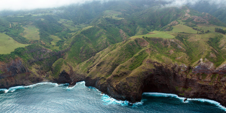 Aerial view of Maui's rocky coastline, shot from a small, low-flying prop plane