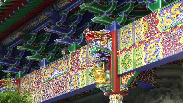 intricately carved beam with a dragon head at po lin monastery near the tan tian buddha statue in hong kong, china