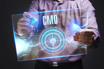 The concept of business, technology, the Internet and the network. A young entrepreneur working on a virtual screen of the future and sees the inscription: CMO