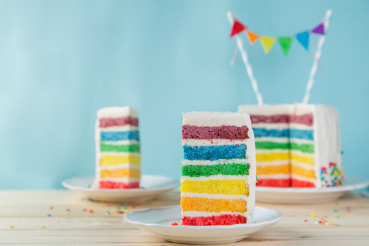 Birthday background - striped rainbow cake with white frosting