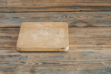 Wood chopping board on wooden background