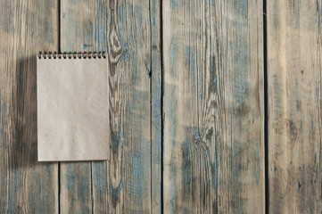 brown blank note book on grunge wood