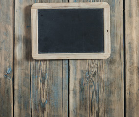 Empty blackboard on wooden wall background