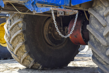Wheel axle of the tractor. Tractor, standing in a row. Agricultural machinery. Parking of...
