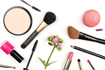 Closeup of makeup accessories, shot from above, on white with copy space