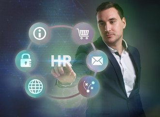 Business, Technology, Internet and network concept. Young businessman working on a virtual screen of the future and sees the inscription: HR