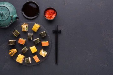 Set of sushi maki and rolls on gray background, top view