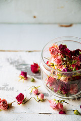 Rose buds tea, tea strainer and glass jar. Selective focus.