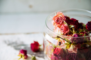 dried rose buds on turquoise wooden surface