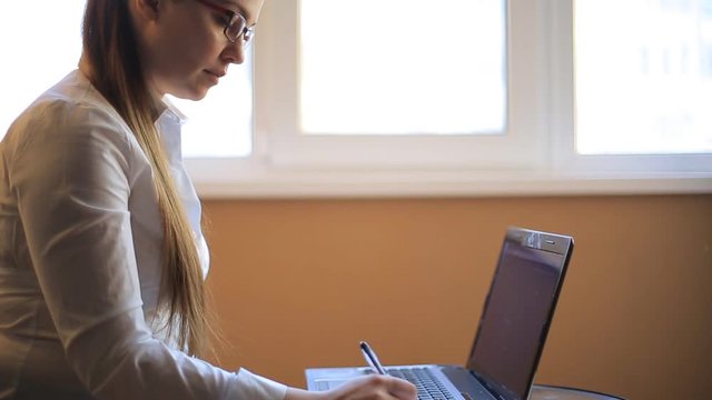 business woman works in office office computer. Compiles a financial report and scolds his employees by phone. Emotions, shouts, swears.
