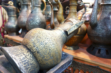 Traditional Turkish crafts. Closeup view of metal jugs with oriental ornament