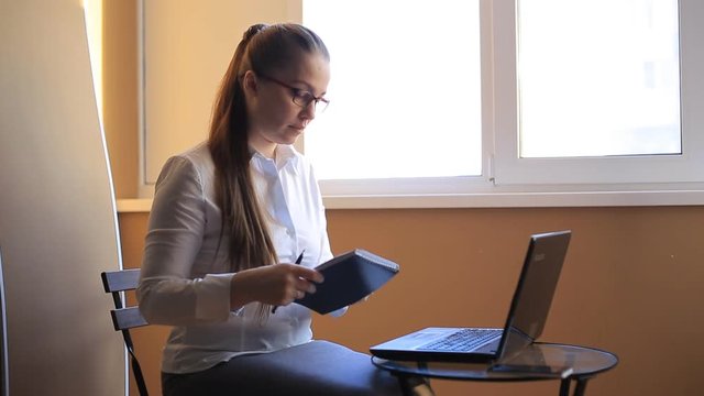 business woman works in office office computer. Compiles a financial report and scolds his employees by phone. Emotions, shouts, swears.
