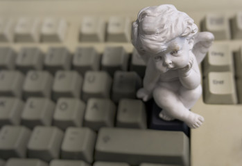 A tired little angel is sitting on my keyboard