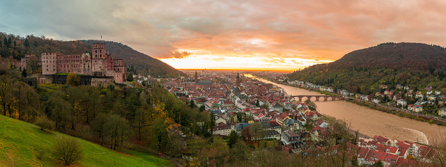 Beautiful aerial view of the Heidelberg old town in Germany during orange sunset.