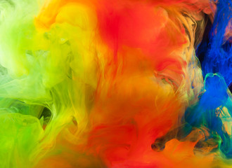 Abstraction of multicolored paints in water on a black background