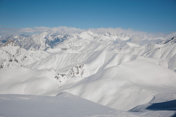 Fototapeta na wymiar Mountain peaks covered with clear white snow