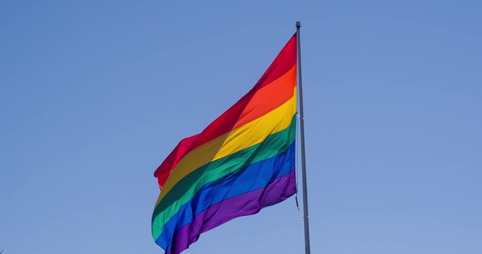 Slow motion gay pride flag blowing in the wind.