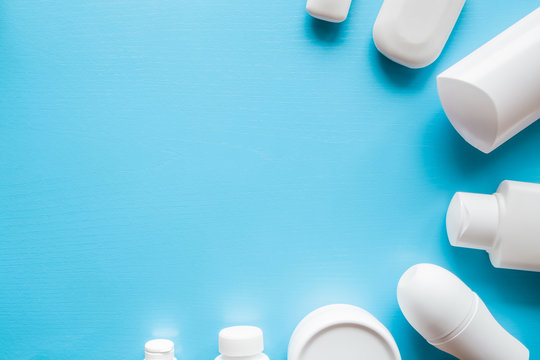 Different, white beauty toiletries on blue background. Mock up for special offers as advertising or other ideas. Cares about a men's, women's and kids hair and body skin. Empty place for text or logo.