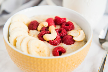 healthy oatmeal Breakfast with banana and raspberry