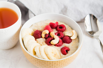 healthy oatmeal Breakfast with banana and raspberry