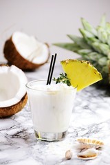 Coconut alcohol cocktail on the light background. Coconut pina colada isolated