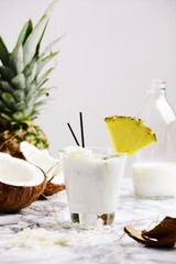 Coconut alcohol cocktail on the light background. Coconut pina colada isolated - obrazy, fototapety, plakaty