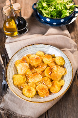 Roasted potatoes on wooden background