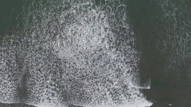 Top aerial view frop drone of Tropical exotic beach with volcanic sand in Bali, Indonesia