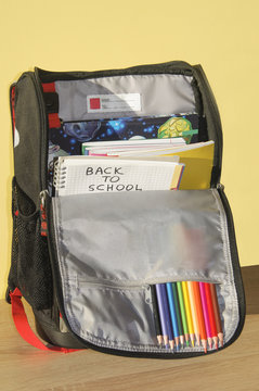 School bag with notebooks and supplies