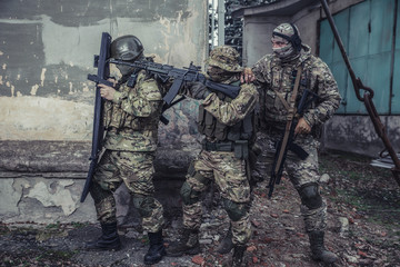 Fototapeta premium Elite squad soldiers with weapons and ammunition