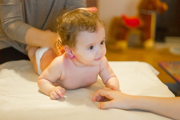 Fototapeta premium Baby massage. Massagist making massage to a small baby.