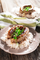 Plate of sausages and sauerkraut on wooden table