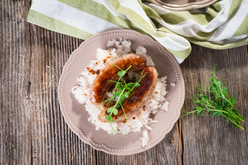 Plate of sausages and sauerkraut on wooden table