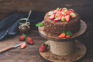 Russian chocolate cake Napoleon with strawberries on the wooden background